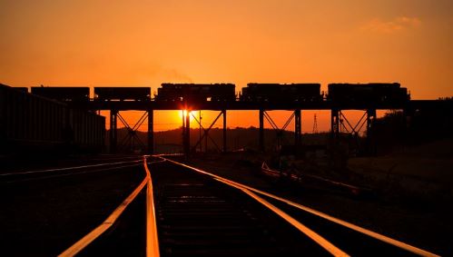Train on bridge at sunset.JPG